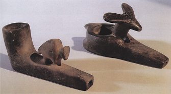 Models of clay tobacco pipe bowls with
                          animal figurines on them, from Mound primary
                          nation